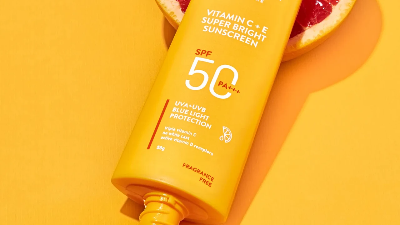 Two mint chocolate milkshakes with whipped cream and green sprinkles.