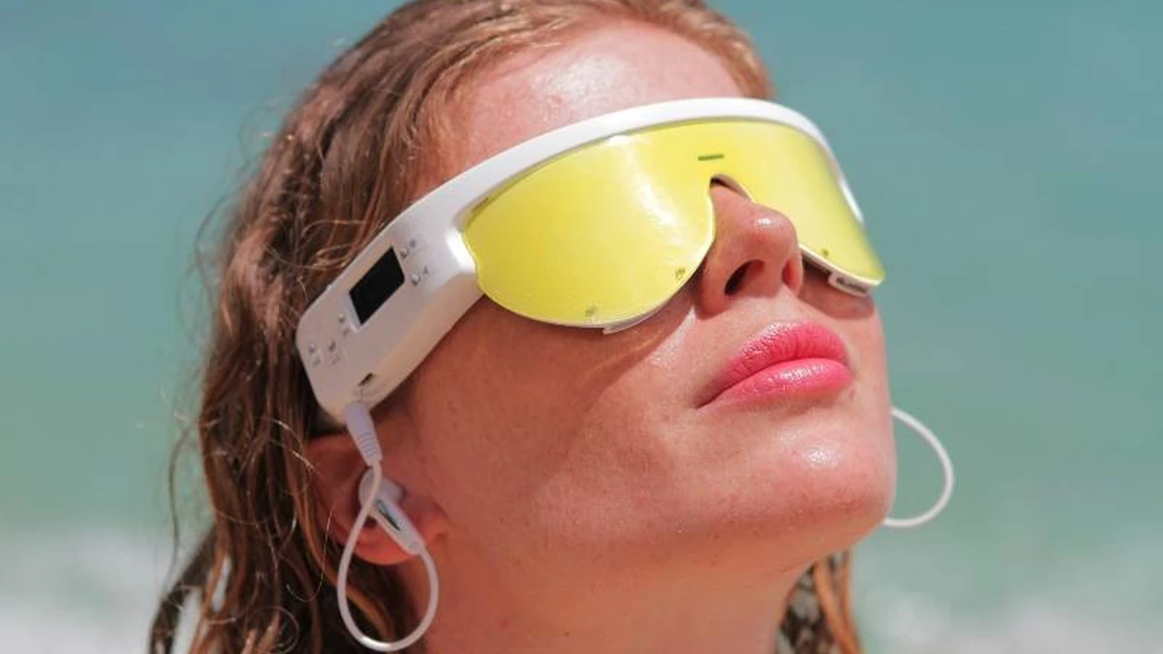 blue bowl of black bean beef tortilla soup on a board with cilantro and shredded cheese in background