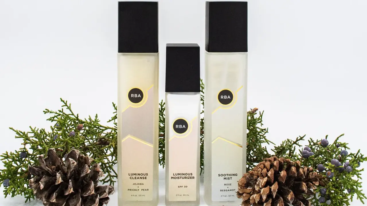 blue bowl of black bean beef tortilla soup on a board with cilantro and shredded cheese in background